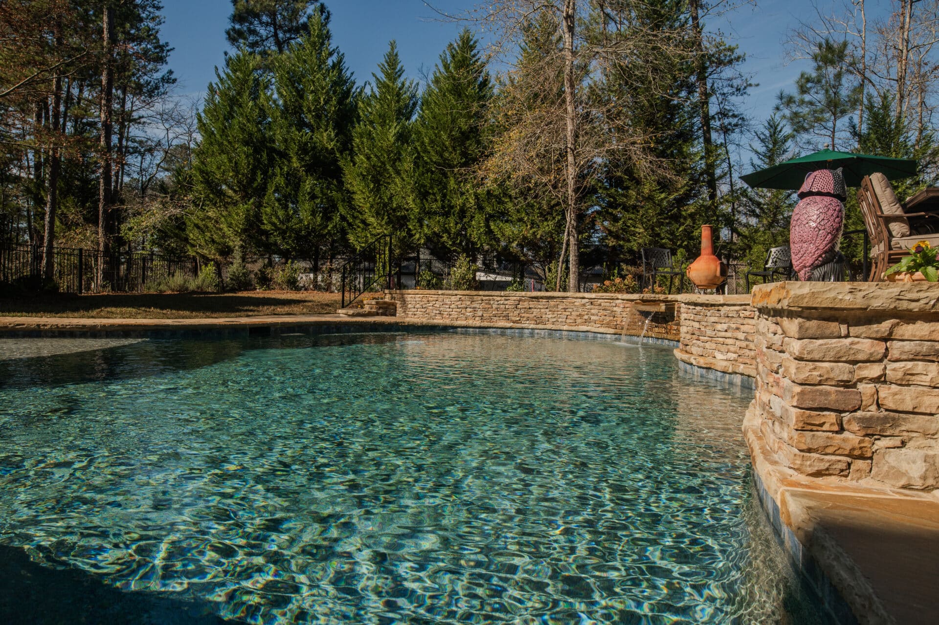 outdoor pool with waterfall feature