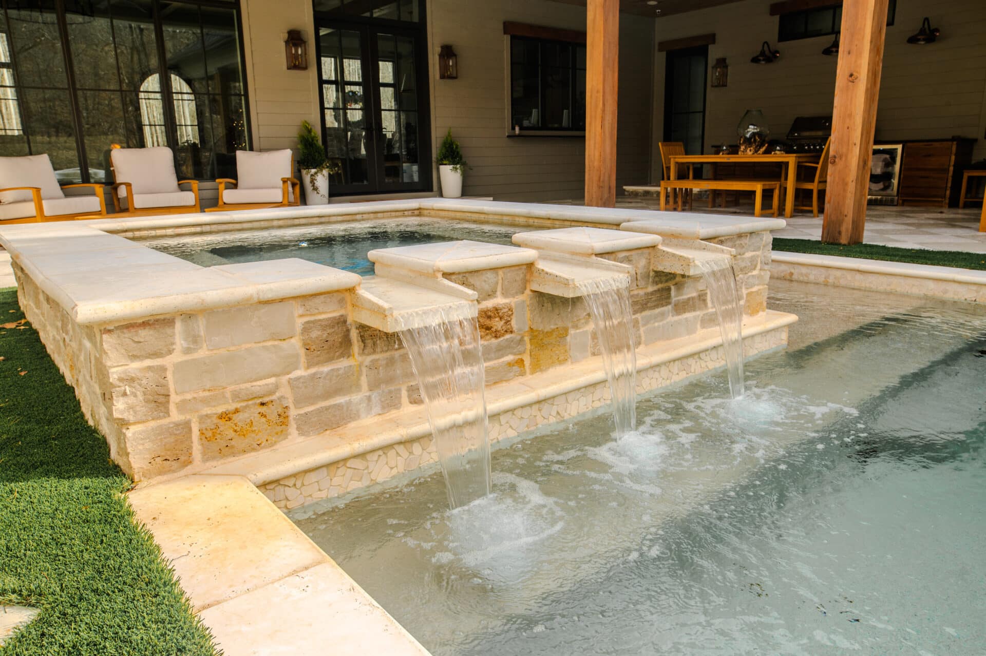 Lake Country Pools project with hot tub, waterfalls, turf, and fire features