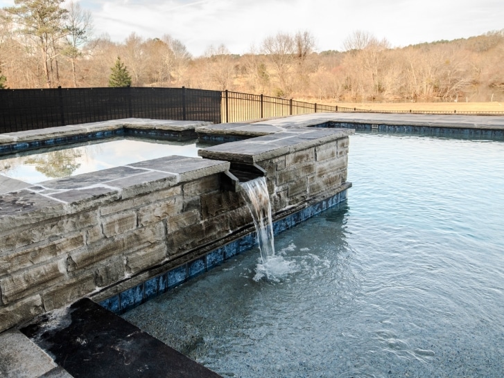 lake country pools project with hot tub and waterfalls