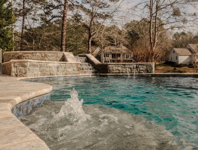 close up shot of a lake country pools project with hot tub and waterfalls